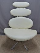 A designer chrome and leather effect pebble swivel chair with graduated design,