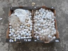 Two boxes of golf balls
