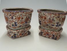 A pair of Oriental jardinieres with stands,