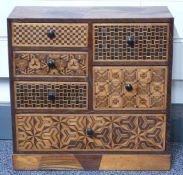 An inlaid Japanese wooden chest of six variously sized drawers,