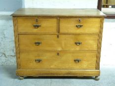 An oak chest of two over two graduated drawers,