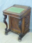A 19thC leather inset mahogany Davenport with moulded supports and fitted interior,