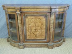 A 19thC burr walnut inlaid credenza with gilt mounts and curved glazed end doors,
