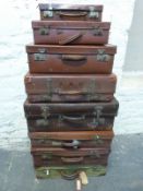 Nine leather and other vintage suitcases,