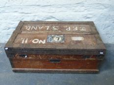 A wooden steamer or travelling trunk with vintage Elder Dempster Lines labels and metal corners,