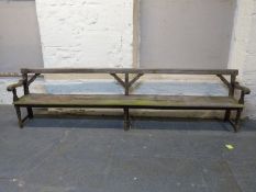 An unusually large late 19th / 20thC oak twin plank settle with shaped arms and back supports,