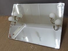 A retro bevelled glass mirror with twin spherical electric lights, perhaps ex theatre dressing room,