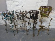 Four wrought iron jardiniere stands with flower decoration,