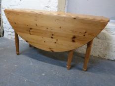 Pine gateleg kitchen table, diameter when opened 154cm,