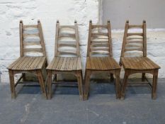 A set of four French oak Gothic style ladderback kitchen chairs
