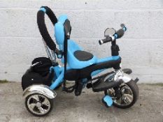 A child's pale blue and black tricycle