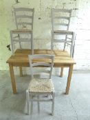 A light oak kitchen table and three chairs,