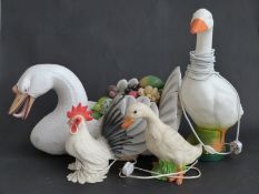 Large swan ornament with faux fruit display, together with several bird lamps,