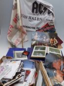 A collection of rock concert related items including hand bills, flyers, ticket stubs, drum sticks,