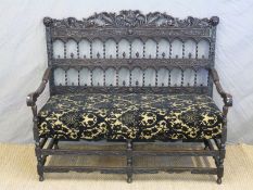 A 19thC ornately carved and pierced possible Colonial settle or bench with barley twist and carved