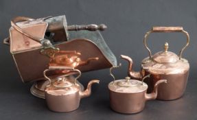A collection of copperware to include coal scuttle with shovel and three various sized kettles