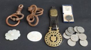 A small collection of commemorative crowns including Guernsey, a mounted horse brass,