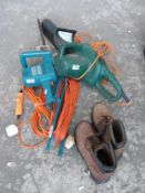 An electric chainsaw together with a Black and Decker hedge trimmer, extension lead,