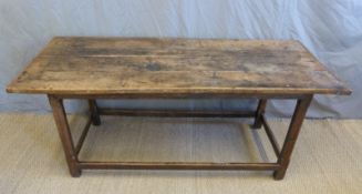 An 18th/19thC oak four plank refectory table with bevelled legs united by a simple oak stretcher,