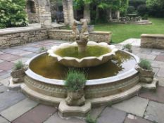 A large stone water feature / courtyard centrepiece with nautilus shell jardinieres,