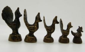 Five Eastern weights formed as cockerels