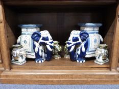 A pair of ceramic elephant seats and four smaller examples,