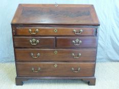 A mahogany bureau with five graduated drawers and fitted interior including stepped drawers,