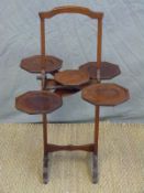 The Monopole folding campaign style cake stand with original maker's plaque.