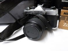 A quantity of cameras and accessories, including Olympus OM-2, Olympus 1:4,5 f=300mm lens,