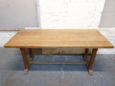 An oak refectory table with bevelled supports,