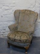 An upholstered wing back armchair belived to be made by the same manufacturer as Titanic furniture.