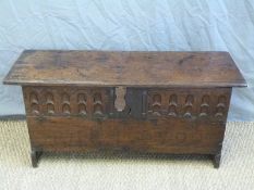 A 16th/ 17thC carved elm coffer of small proportions with original hinges and cast iron lockplate