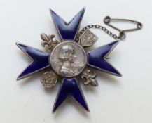 A silver and blue guilloche enamel badge from the Nightingale School,