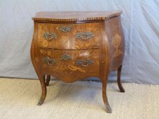A 19thC French inlaid mahogany bombe chest of two drawers with ormolu mounts