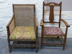 An oak framed bergere armchair and another oak Arts and Crafts armchair