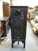 A chinoiserie decorated glazed corner cabinet,