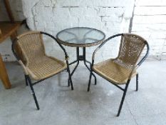 A glass table and two chairs, diameter of table 61,