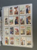 A collector's folder containing a large collection of cigarette cards,
