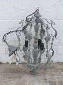 A three branch wrought iron style electric light fitting,