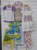 Eight dolls / children's dresses or part outfits some with lace decoration and printed patterns