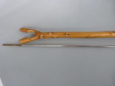 A yew or holly gun rest / thumb stick and a cleaning rod,