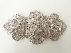 Indian or Eastern white metal belt buckle decorated with embossed figures,
