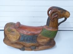 A carved and painted wooden rocking ram or goat,