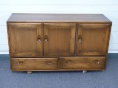 Ercol elm sideboard with cupboards above two drawers W130 x D43 x H77cm