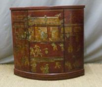 A Chinese lacquer side cabinet with red ground and lacquer figure decoration,