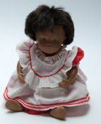 Sasha doll with pink lips, blue eyeshadow, brown hair, and red and white outfit, 30cm tall.