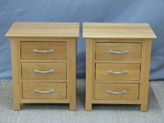 A pair of light oak bedside chests of drawers,