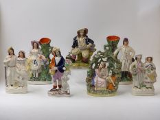 Seven Staffordshire figures including a pair of spill vases,