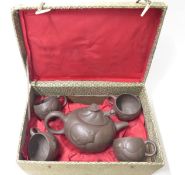 A cased Chinese Yixing tea set depicting dragons, marked to inner lid,