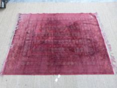 Turkoman rug on red ground with fringed ends,